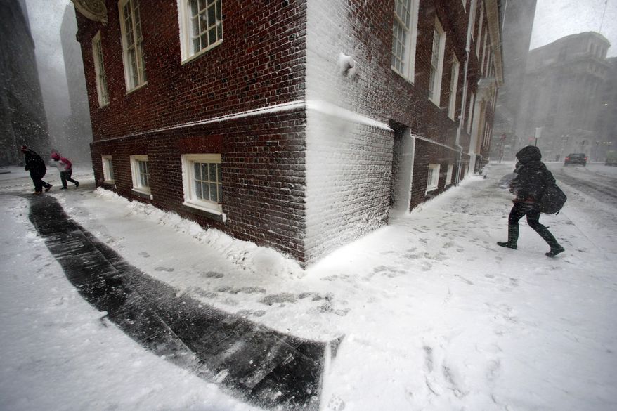 People walk in the wind-driven snow during a winter storm Tuesday, March 14, 2017, in Boston. (AP Photo/Michael Dwyer)