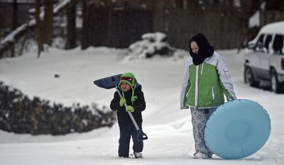 Aiden Cadet, 3, and his mother Kristin Petrucci are ready for work of play as they venture out into the winter storm Tuesday, March 14, 2017 in Norwich, Conn.. (Sean D. Elliot/The Day via AP)