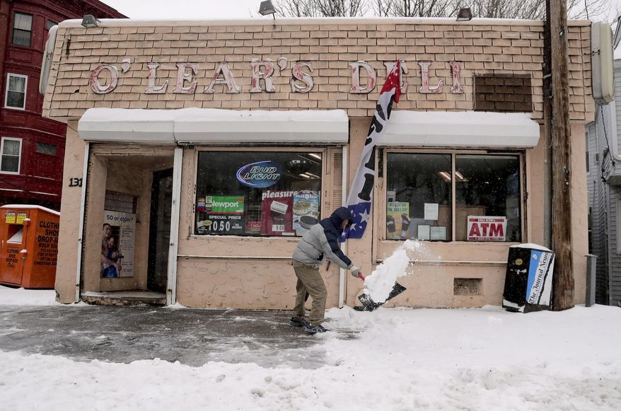 A store employee clears snow from the front of a deli during a snow storm, Tuesday, March 14, 2017, in Yonkers, N.Y. New York Gov. Andrew Cuomo has declared a state of emergency Tuesday for all of New York's 62 counties, including New York City's five boroughs. (AP Photo/Julie Jacobson)