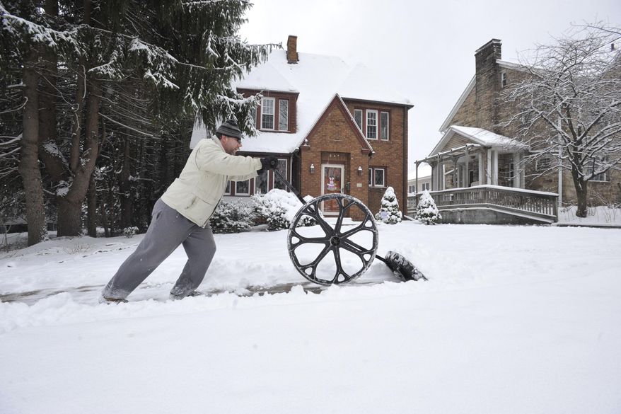 Jeffrey Hale of Johnstown, Pa. uses his snow wolf to clear the sidewalk around his home and neighbors during a winter storm Tuesday, March 14, 2017. (Todd Berkey /The Tribune-Democrat via AP)