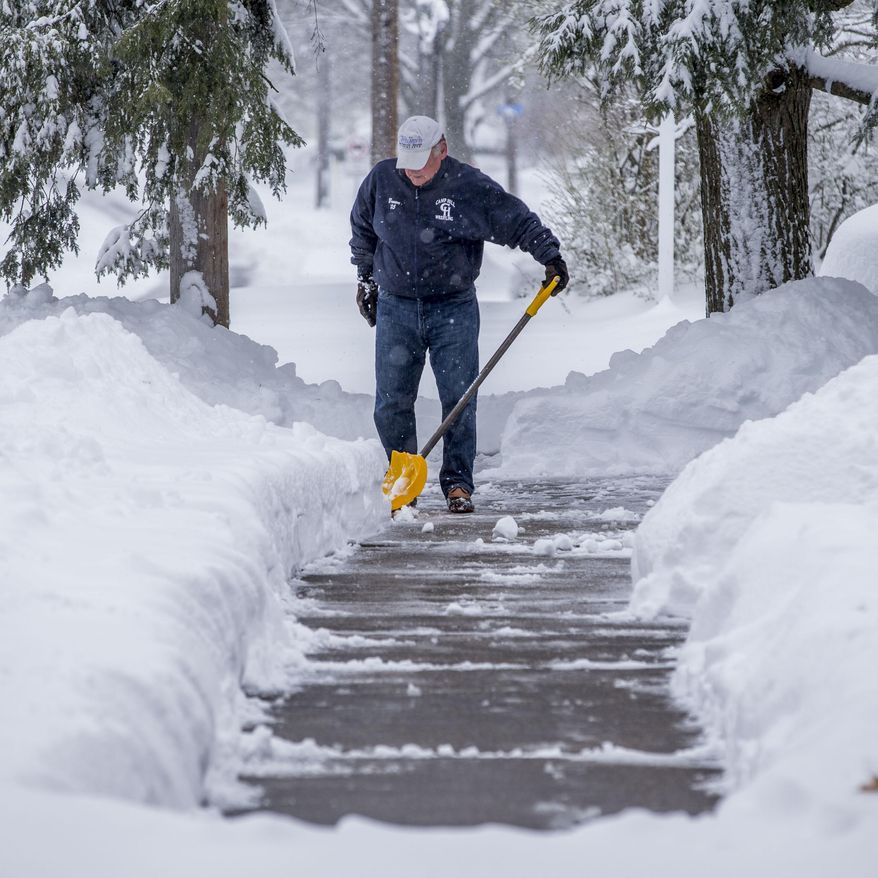 Mark Brown III, Camp Hill, shovels his sidewalk and driveway after a winter storm dumped over a foot of snow Tuesday, March 14, 2017. The powerful nor’easter grounded nearly 6,000 flights, knocked out power to over 180,000 customers from Virginia northward, closed schools in cities big and small and prompted dire warnings to stay off the roads. Amtrak suspended service and the post office halted mail delivery. (Mark Pynes /PennLive.com via AP)