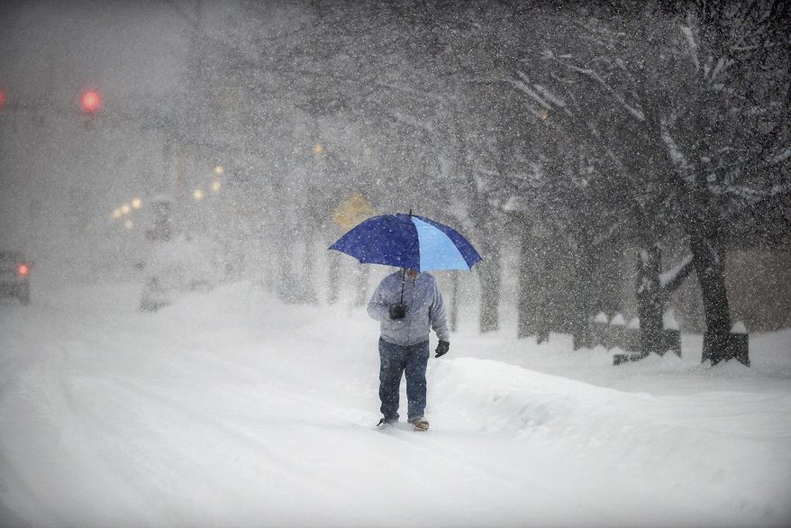A man walks on Wyoming Avenue on Tuesday, March 14, 2017, in Scranton, Pa., during a severe winter storm. ( Butch Comegys / The Times & Tribune via AP)