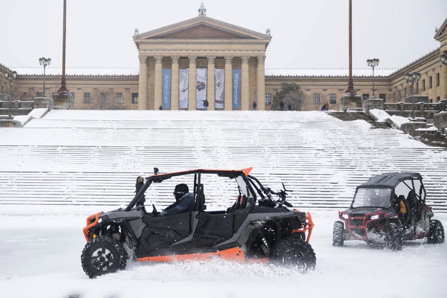 People drive all terrain vehicles during a winter storm at the Philadelphia Museum of Art in Philadelphia, Tuesday, March 14, 2017. (AP Photo/Matt Rourke)