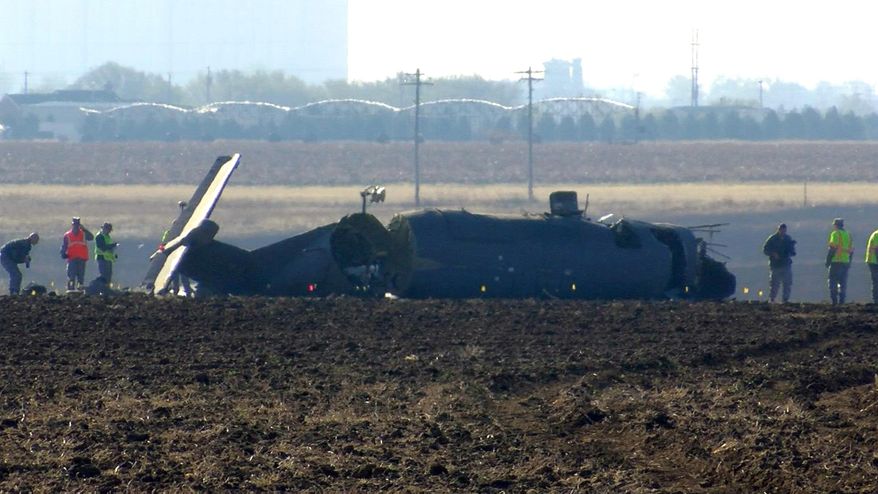 This frame grab from video supplied by KFDA-TV shows investigators looking over the broken fuselage of an Air Force plane Wednesday, March 15, 2017, in Clovis, N.M. The Air Force says three service members were killed when the single-engine reconnaissance and surveillance plane crashed in eastern New Mexico during a training flight. (KFDA-TV via AP)