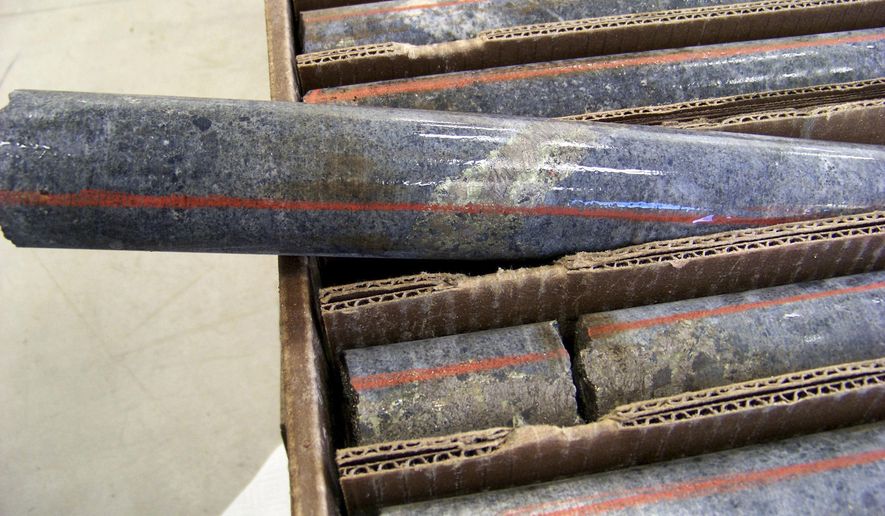 FILE - In this Oct. 4, 2011, file photo, a core sample drilled from underground rock near Ely, Minn., shows a band of shiny minerals containing copper, nickel and precious metals, center, that Twin Metals Minnesota LLC, hopes to mine near the Boundary Waters Canoe Area Wilderness in northeastern Minnesota. Friends and foes of copper-nickel mining in northeastern Minnesota are mobilizing their supporters for a public meeting in Duluth on Thursday on a proposal made in the final weeks of the Obama administration to bar over 234,000 acres of land near the Boundary Waters Canoe Area from further minerals exploration or mining for at least 20 years. (AP Photo/Steve Karnowski, File)