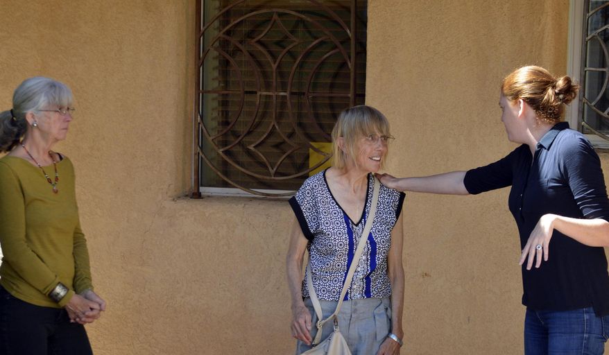 Bekah Wolf, right, of the National Lawyers Guild, acts as a federal immigration agent during a role playing exercise for activists in Albuquerque, N.M. on Wednesday, March 15, 2017. New Mexico activists are joining advocacy groups across the country in providing training to people seeking to help immigrants avoid deportation. The SouthWest Organizing Project hosted a training session Wednesday on accompanying immigrants to court and supporting them when immigration authorities arrive. (AP Photo/Russell Contreras)