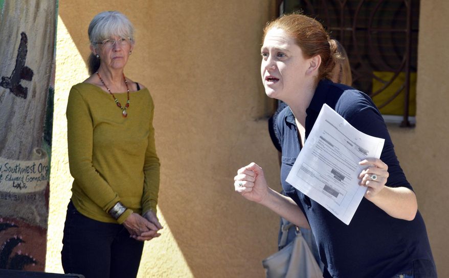 Bekah Wolf, center, of the National Lawyers Guild, acts as a federal immigration agent during a role playing exercise for activists in Albuquerque, N.M. on Wednesday, March 15, 2017. New Mexico activists are joining advocacy groups across the country in providing training to people seeking to help immigrants avoid deportation. The SouthWest Organizing Project hosted a training session Wednesday on accompanying immigrants to court and supporting them when immigration authorities arrive. (AP Photo/Russell Contreras)