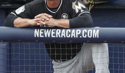 Miami Marlins manager Don Mattingly watches from the dugout during a spring training baseball game against the New York Mets, Monday, March 13, 2017, in Port St. Lucie, Fla. (AP Photo/John Bazemore)