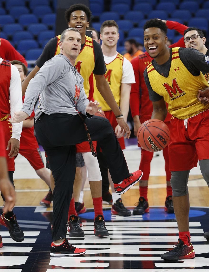 Maryland head coach Mark Turgeon, center, reacts as he attempts a half-court shot during practice at the NCAA college basketball tournament, Wednesday, March 15, 2017 in Orlando, Fla. (AP Photo/Wilfredo Lee) **FILE**