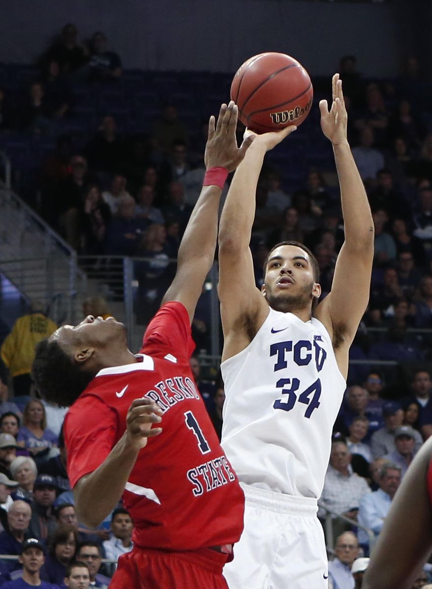 TCU guard Kenrich Williams (34) shoots against Fresno State guard Jaron Hopkins (1) during the second half of an NCAA college basketball game in the NIT in Fort Worth, Texas, Wednesday, March 15, 2017. (Paul Moseley/Star-Telegram via AP)