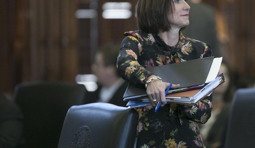 Republican state Sen. Lois Kolkhorst, author of Senate Bill 6, prohibiting transgender-friendly bathrooms, gathers her notes before she presents the bill on the floor of the senate for debate at the state capitol in Austin, Texas. (Ralph Barrera/Austin American-Statesman via AP)