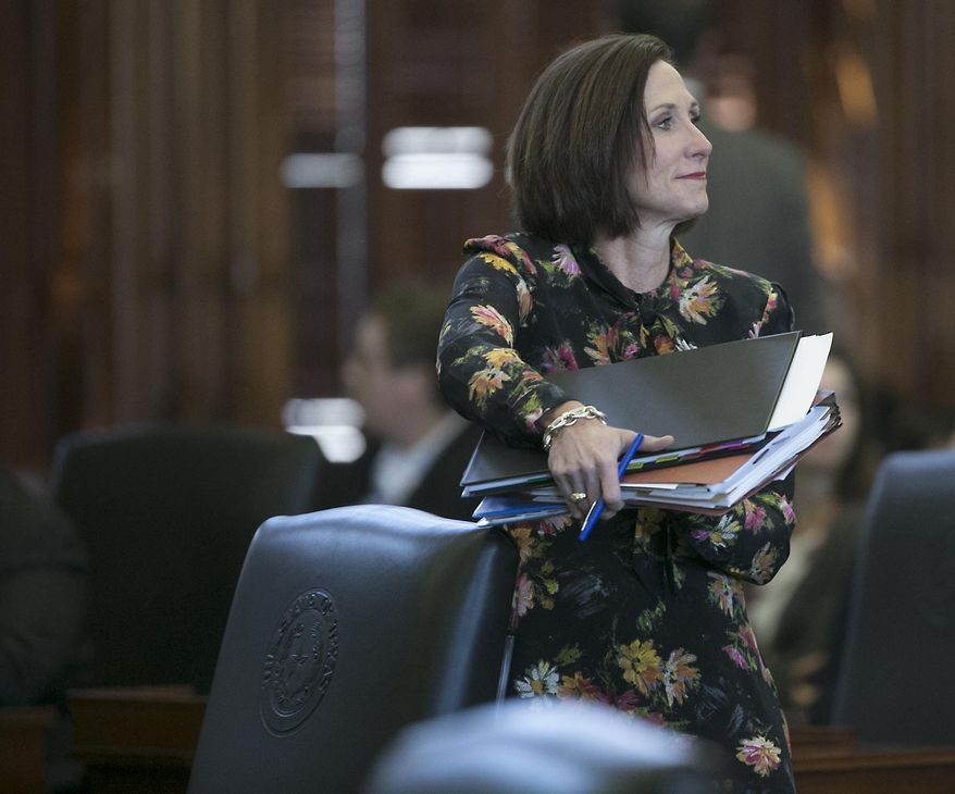 Republican state Sen. Lois Kolkhorst, author of Senate Bill 6, prohibiting transgender-friendly bathrooms, gathers her notes before she presents the bill on the floor of the senate for debate at the state capitol in Austin, Texas. (Ralph Barrera/Austin American-Statesman via AP)