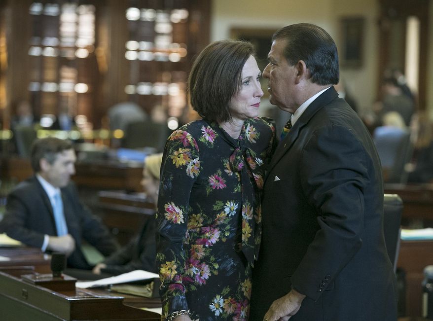 Republican state Sen. Lois Kolkhorst, author of Senate Bill 6, prohibiting transgender-friendly bathrooms, speaks with Democratic state Sen. Eddie Lucio, Jr., who has said he will endorse the legislation, as she presents the bill on the floor of the senate for debate at the state capitol in Austin, Texas. At this point, Lucio is the only Democrat supporting the bill. (Ralph Barrera/Austin American-Statesman via AP)