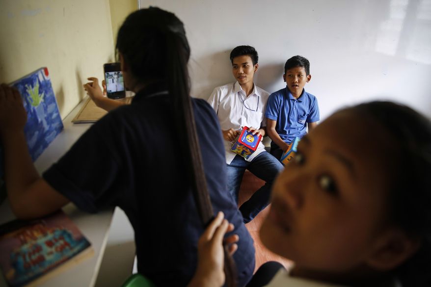 In this March 11, 2017, photo, Christian Burmese refugees play before the start of their lessons in Kuala Lumpur, Malaysia. An Associated Press analysis suggests that the people hurt most by President Donald Trump's planned deep cuts in refugee visas are from not any of the six Muslim countries listed in his travel ban, but Myanmar. (AP Photo/Joshua Paul)
