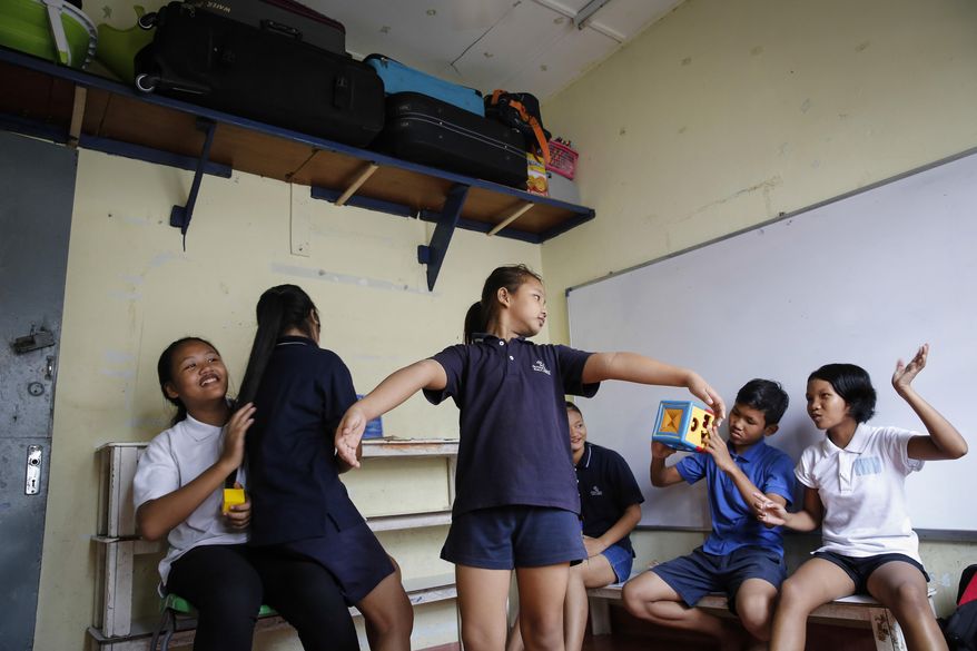 In this March 11, 2017, photo, Christian Burmese refugees play before the start of their lessons in Kuala Lumpur, Malaysia. An Associated Press analysis suggests that the people hurt most by President Donald Trump's planned deep cuts in refugee visas are from not any of the six Muslim countries listed in his travel ban, but Myanmar. (AP Photo/Joshua Paul)