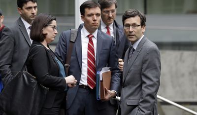 Attorney General Bob Ferguson, right, stands with members of his staff, including Solicitor General Noah Purcell, center, and Civil Rights Unit Chief Colleen Melody, second left, before speaking with the media on the steps of the federal courthouse after an immigration hearing there Wednesday, March 15, 2017, in Seattle. Hours before it was to take effect, President Donald Trump&#x27;s revised travel ban was put on hold Wednesday by a federal judge in Hawaii. In a new court filing Wednesday, Ferguson said the state supports the arguments made in a related case filed by an immigrant rights group based in Seattle that alleges the ban discriminates against Muslims and violates federal immigration law. (AP Photo/Elaine Thompson)