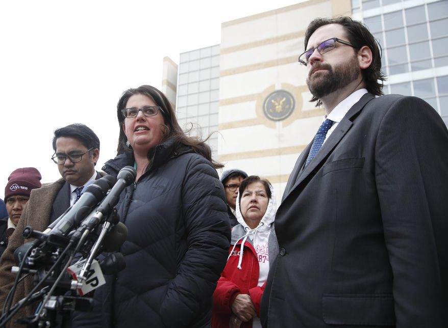 Becca Heller of the International Refugee Assistance Project, center, flanked by Omar Jadwat of the ACLU, left, and Justin Cox of the National Immigration Law Center, representing the plaintiffs, speaks to reporters outside court in Beltsville, Md., Wednesday, March 15, 2017. A federal judge in Maryland says he will issue a ruling in a lawsuit challenging President Donald Trump's revised travel ban. (AP Photo/Manuel Balce Ceneta)