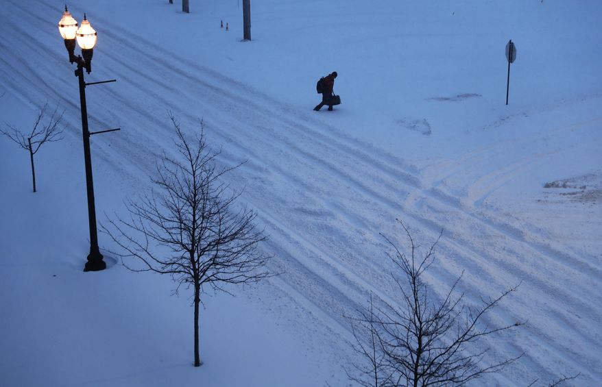 A pedestrian walks down a snow-filled street to get to a hotel during a snowstorm in Lewiston, Maine, Tuesday, March 14, 2017. A blustery late-season storm is hitting the Northeast, closing schools and prompting dire warnings to stay off the roads. (AP Photo/David Goldman)
