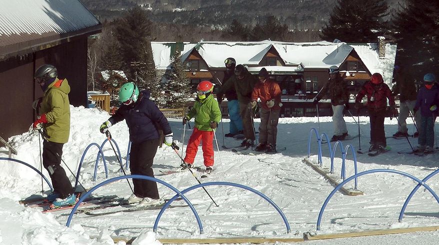 Skiers line up for the Vortex Powder Express chairlift at Pats Peak ski area in Henniker, New Hampshire on Wednesday, March 15, 2017. After a warm February, resorts across the region were picked up more than a foot of fresh powder in Tuesday's storm. (AP Photo/Holly Ramer)