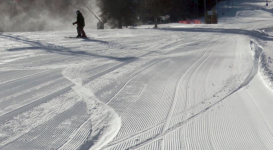 A skier navigates a trail in sunny, windy weather on Wednesday, March 15, 2017, at Pats Peak ski area in Henniker, N.H. A storm Tuesday dumped more than a foot of snow across the region, aiding ski areas that had been making snow since a stretch of warm days in February. (AP Photo/Holly Ramer)