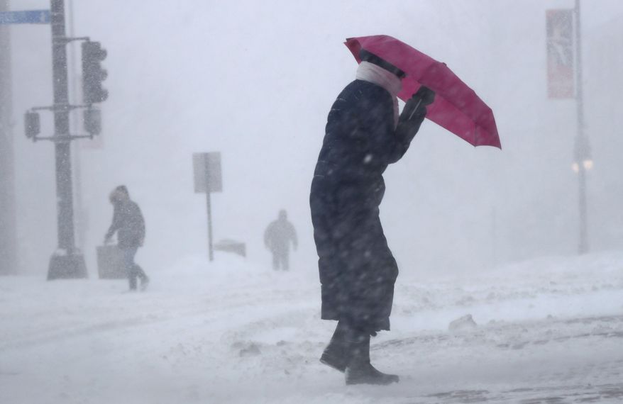 Cherie Burke contends with blowing snow during a blustery storm, Tuesday, March 14, 2017, in Portland, Maine. A late-season storm is hitting the Northeast, closing schools and prompting dire warnings to stay off the roads. (AP Photo/Robert F. Bukaty)