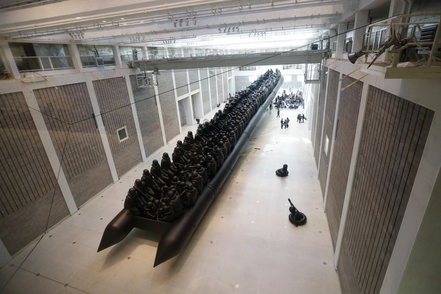 An installation made by Chinese activist and artist Ai Weiwei is displayed at the National Gallery in Prague, Czech Republic, Thursday, March 16, 2017. A 70-metre-long inflatable boat with life-size figures of 258 refugees prepared for the gallery, called "The Law of the Journey," is one of the artists biggest work of art so far. (AP Photo/Petr David Josek)