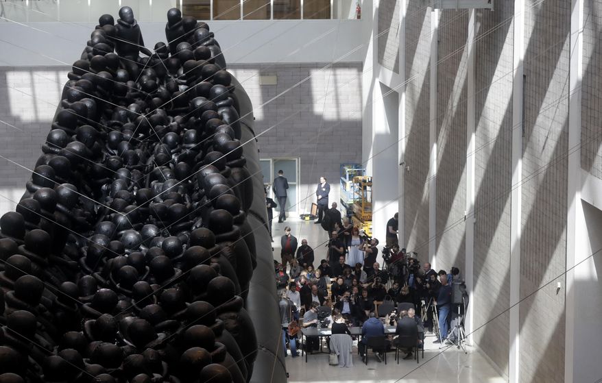 An installation made by Chinese activist and artist Ai Weiwei is displayed at the National Gallery in Prague, Czech Republic, Thursday, March 16, 2017. A 70-metre-long inflatable boat with life-size figures of 258 refugees prepared for the gallery, called "The Law of the Journey," is one of the artist's biggest work of art so far. (AP Photo/Petr David Josek) (AP Photo/Petr David Josek)