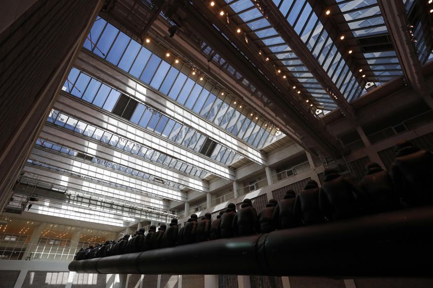 An installation made by Chinese activist and artist Ai Weiwei is displayed at the National Gallery in Prague, Czech Republic, Thursday, March 16, 2017. A 70-metre-long inflatable boat with life-size figures of 258 refugees prepared for the gallery, called "The Law of the Journey," s one of the artist's biggest work of art so far. (AP Photo/Petr David Josek)