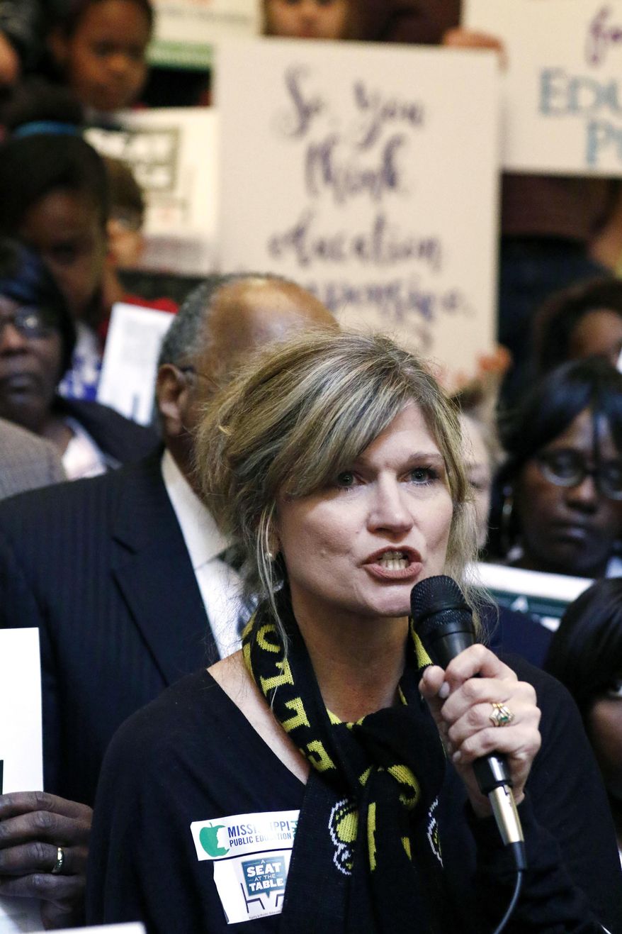 Leslie Fye, a Starkville mother of two children in the Starkville Oktibbeha Consolidated School District, speaks about the needs of the smaller school districts, as she addresses several hundred parents, educators, education activists, and students at an education rally at the Capitol in Jackson, Miss., Thursday, March 16, 2017. Advocates for public schools are opposing legislative leaders' plans to rewrite the state's school funding formula. (AP Photo/Rogelio V. Solis)