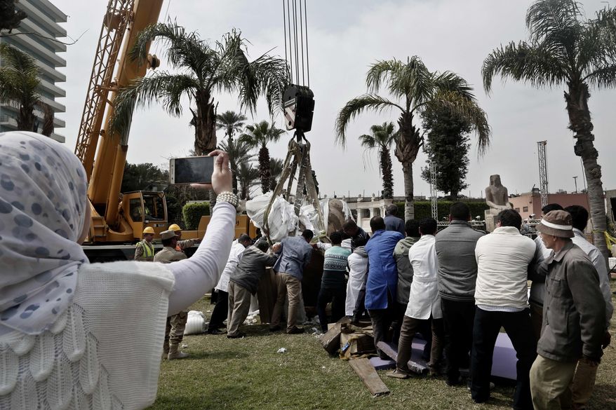 Antiquities workers bring down stone parts of the statue of King Psamtek l at the Egyptian museum in Cairo, Thursday, March 16, 2017. Egypt&#39;s antiquities minister Khaled el-Anani, told at a news conference that the colossus discovered last week in an eastern Cairo suburb almost certainly depicts Psamtek I, who ruled Egypt between 664 and 610 B.C. (AP Photo/Nariman El-Mofty)
