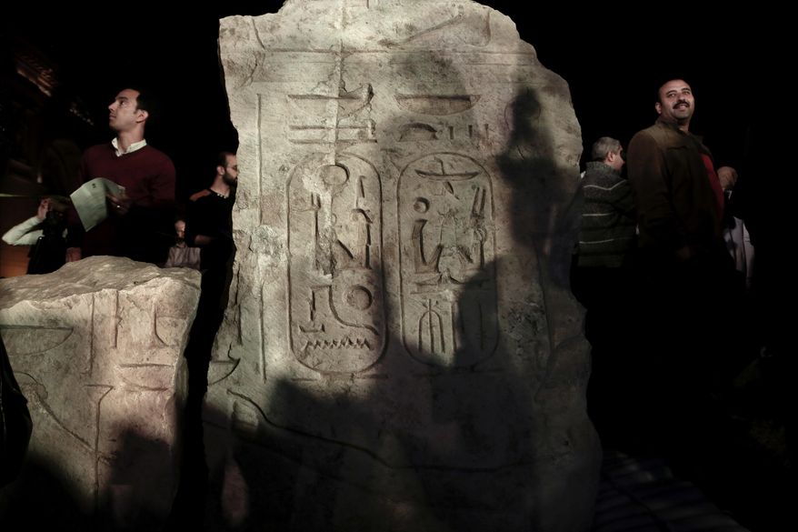 Men gather around a stone part of the statue of King Psamtek l after a press conference at the Egyptian museum in Cairo, Thursday, March 16, 2017. Egypt&#39;s antiquities minister Khaled el-Anani, told at a news conference that the colossus discovered last week in an eastern Cairo suburb almost certainly depicts Psamtek I, who ruled Egypt between 664 and 610 B.C. (AP Photo/Nariman El-Mofty)
