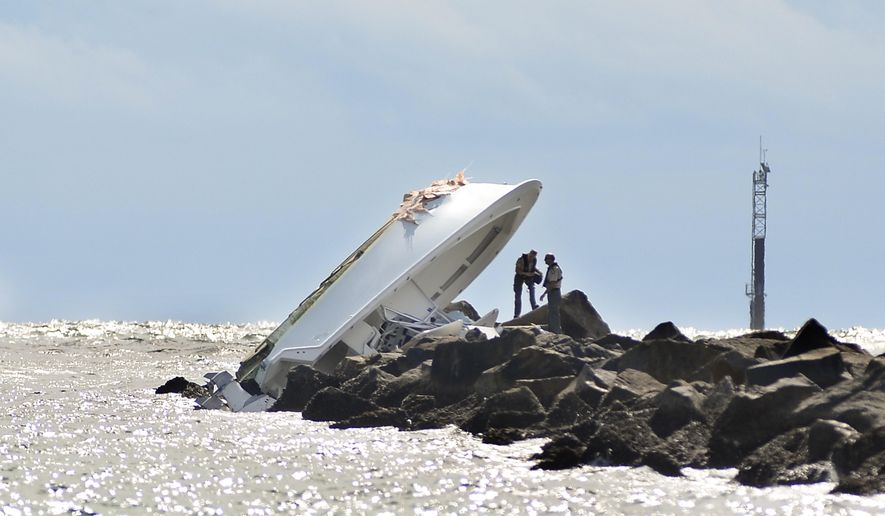 FILE - In this Sept. 25, 2016, file photo, investigators inspect an overturned boat as it rests on a jetty after a crash off Miami Beach, Fla. Miami Marlins pitcher Jose Fernandez was the &amp;quot;probable&amp;quot; operator of a speeding boat that crashed into a Miami Beach jetty on Sept. 25, 2016, killing the star baseball star and two other men, according to a report issued Thursday, March 16, 2017, by the Florida Fish and Wildlife Conservation Commission, which investigated the accident.  (AP Photo/Gaston De Cardenas, File)