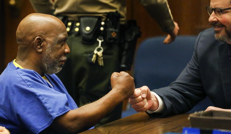 Andrew Wilson, left, exchanges a fist bump with his attorney Adam Grant at the start of a hearing in Los Angeles Superior Court on Wednesday, March 15, 2017 in Los Angles. Judge Laura Priver ordered the release of Wilson, who spent more than three decades in prison for murder after prosecutors conceded he did not get a fair trial. (Mark Boster/Los Angeles Times via AP, Pool)