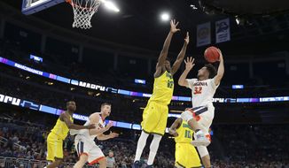 Virginia guard London Perrantes (32) goes up for a shot against Devontae Cacok (15) during the second half of a first-round men&#39;s college basketball game in the NCAA Tournament, Thursday, March 16, 2017, in Orlando, Fla. Virginia defeated UNC Wilmington 76-71. (AP Photo/Gary McCullough)