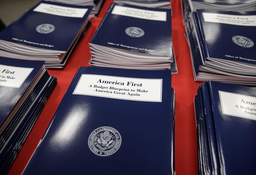 Copies of President Donald Trump's first budget are displayed at the Government Printing Office in Washington, Thursday, March, 16, 2017. Trump unveiled a $1.15 trillion budget on Thursday, a far-reaching overhaul of federal government spending that slashes many domestic programs to finance a significant increase in the military and make a down payment on a U.S.-Mexico border wall. (AP Photo/J. Scott Applewhite)