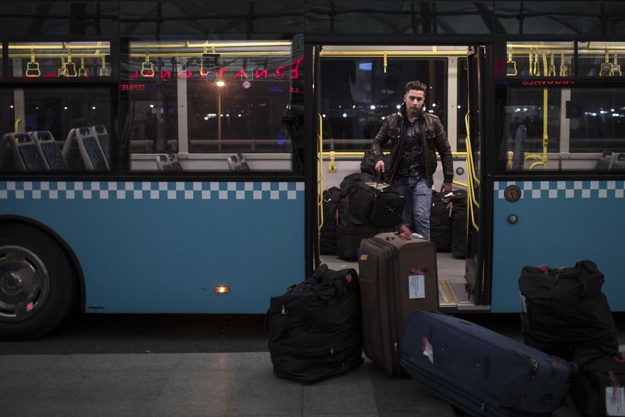 Dawood, 15, carries the family bags as they arrive in the departure area of the airport in Irbil, Iraq, Wednesday, March 15, 2017. An Iraqi family has landed in the United States as a federal court blocked a travel ban that would have kept others like them out of the country for 120 days. Nadia Hanan Madalo and her family arrived in San Diego to be reunited with Madalo’s siblings and mother, who arrived as refugees in recent years. (AP Photo/Felipe Dana)