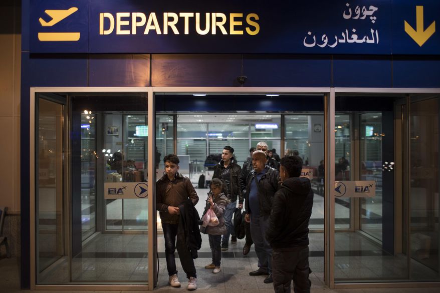 Oraha, 12, left, Noor, 8, center, and Salim Tobiya Kato, 56, arrive at the Erbil International Airport in Irbil, Iraq, Wednesday, March 15, 2017. An Iraqi family has landed in the United States as a federal court blocked a travel ban that would have kept others like them out of the country for 120 days. Nadia Hanan Madalo and her family arrived in San Diego to be reunited with Madalo’s siblings and mother, who arrived as refugees in recent years. (AP Photo/Felipe Dana)