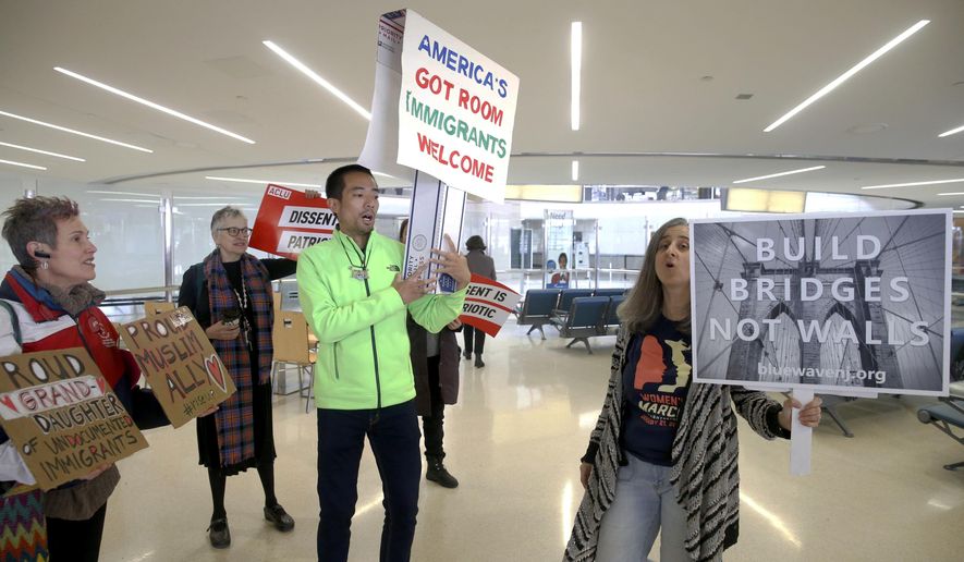 Protestors chant in Terminal B at the Newark International Airport prior to addressing the media, in Newark, NJ., Thursday March 16, 2017. A diverse group of advocates and immigrant New Jerseyans gathered to condemn Trump&#39;s updated travel ban. (Aristide Economopoulos/NJ Advance Media via AP)