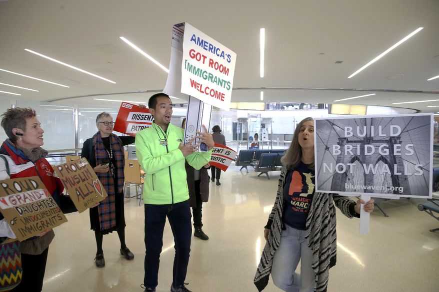 Protestors chant in Terminal B at the Newark International Airport prior to addressing the media, in Newark, NJ., Thursday March 16, 2017. A diverse group of advocates and immigrant New Jerseyans gathered to condemn Trump&#39;s updated travel ban. (Aristide Economopoulos/NJ Advance Media via AP)