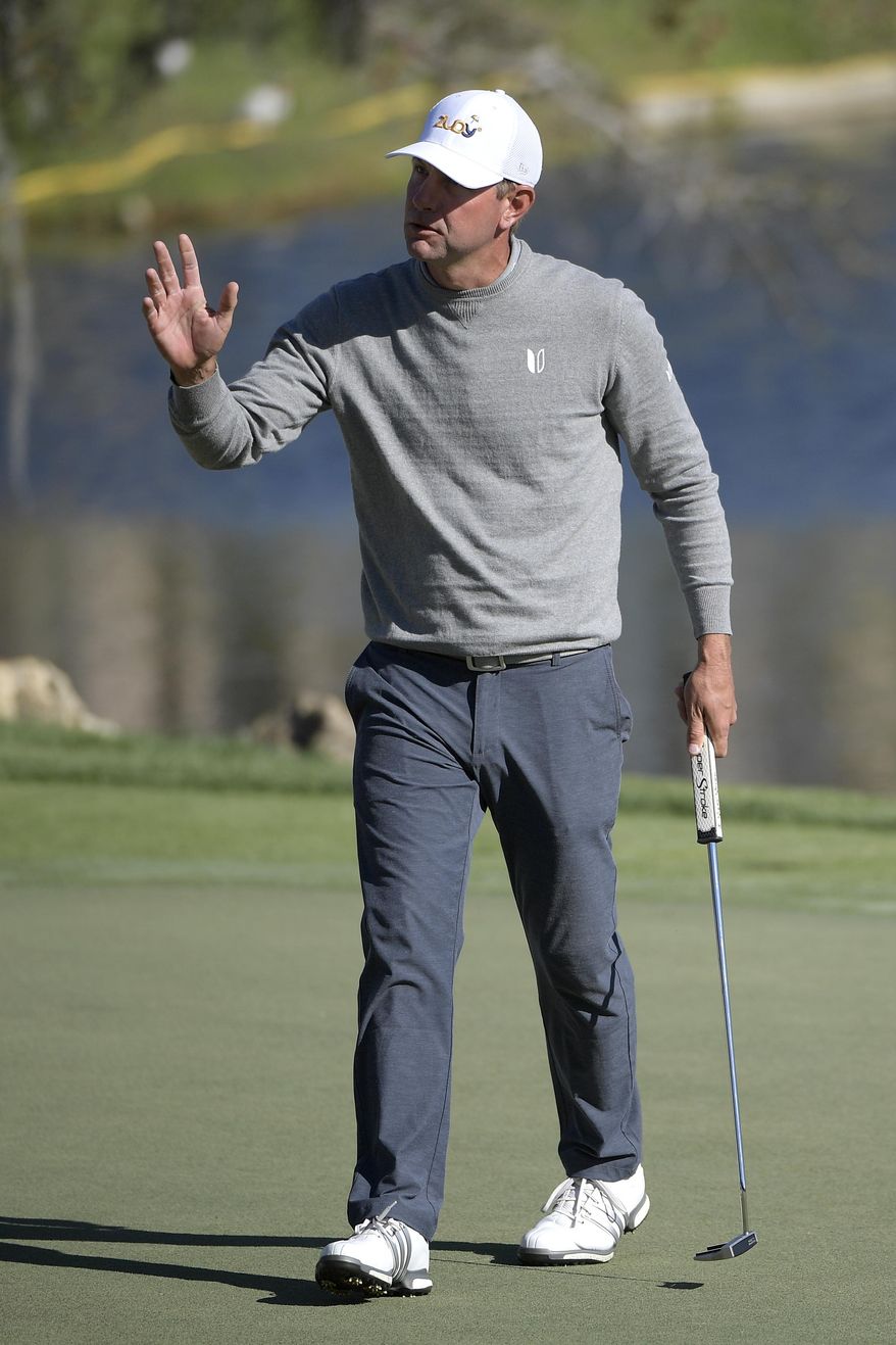 Lucas Glover acknowledges the crowd after sinking his putt on the 18th green during the first round of the Arnold Palmer Invitational golf tournament in Orlando, Fla., Thursday, March 16, 2017. (AP Photo/Phelan M. Ebenhack)