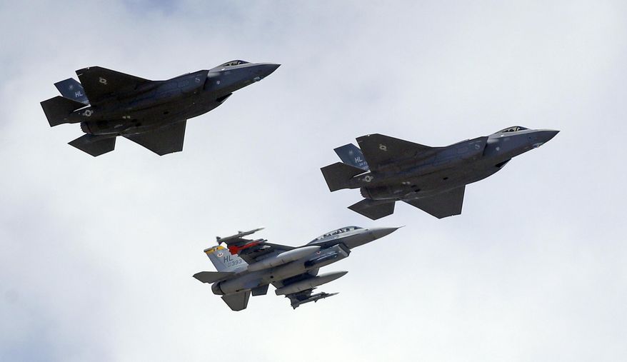 This Sept. 2, 2015, file photo shows an F-16, below, escorting two F-35 jets, above, after arriving the latter arrived at Hill Air Force Base in Utah. The U.S. and its Asia-Pacific allies are rolling out their new stealth fighter jet, a cutting-edge plane that costs about $100 million each. (AP Photo/Rick Bowmer, File)
