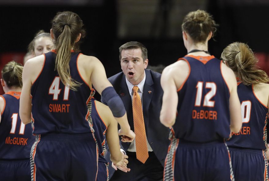 Bucknell head coach Aaron Roussell, center, speaks with his players during a timeout in the first half of a first-round game against Maryland in the women's NCAA college basketball tournament in College Park, Md., Friday, March 17, 2017. (AP Photo/Patrick Semansky)