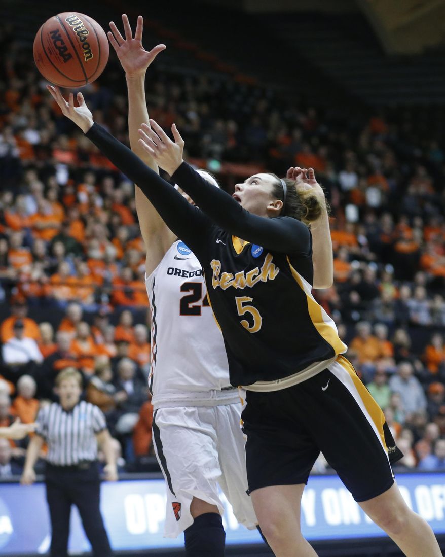 Long Beach State's Gigi Hascheff (5) shoots past Oregon State's Sydney Wiese, rear, during the first half of a first-round game in the women's NCAA college basketball tournament Friday, March 17, 2017, in Corvallis, Ore. (AP Photo/Timothy J. Gonzalez)