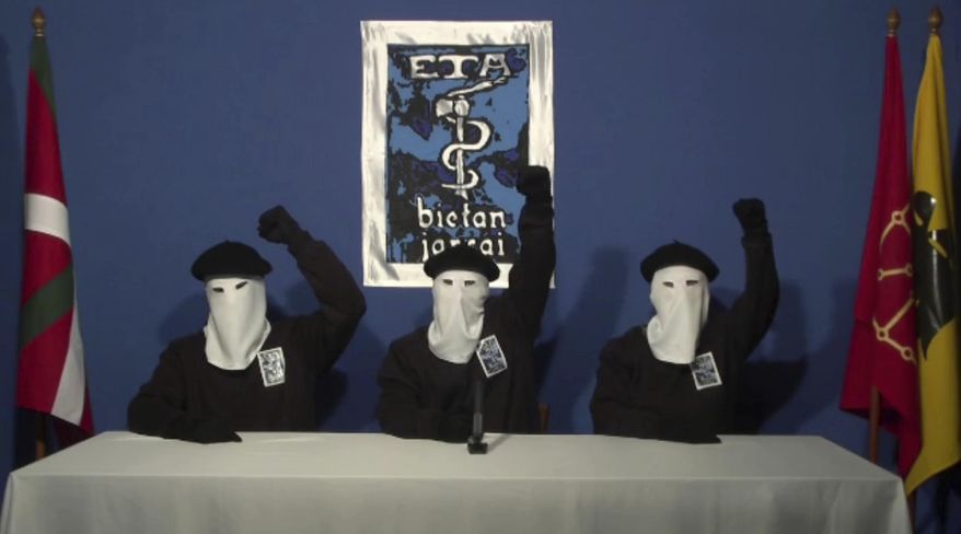 FILE - In this file image made from video provided on Oct. 20, 2011, masked members of the Basque separatist group ETA hold up their fists in unison following a news conference at an unknown location. Spanish media are reporting that ETA are set to announce Friday March 17, 2017 its new initiative to lay down weapons aimed at speeding the stalled process of disbanding. (AP Photo/Gara via AP, File)