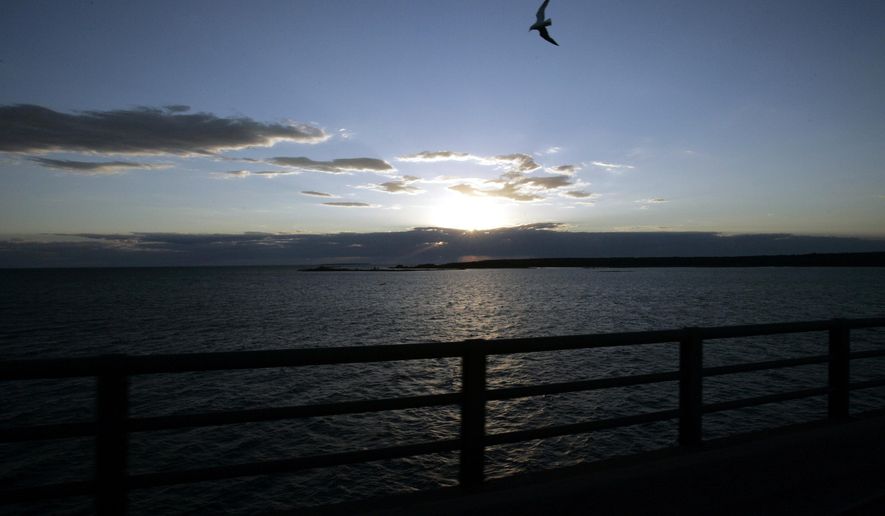 FILE - In a June 30, 2005 file photo, Michigan's Upper Peninsula and Lake Michigan is seen from the Mackinac Bridge in Mackinaw City, Mich. President Donald Trump wants to eliminate federal support of a program that addresses the Great Lakes' most pressing environmental threats. Trump's 2018 budget released Thursday, March 16, 2017, would remove all funding for the Great Lakes Restoration Initiative, which has received strong support from members of Congress in both parties since President Barack Obama established it in 2009. (AP Photo/Carlos Osorio, File)