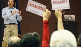 Audience members hold signs reading, &quot;DISAGREE&quot; as U.S. Rep. Scott Perry, R-Pa., speaks during a town hall meeting Saturday, March 18, 2017 in Red Lion, Pa. Perry&#39;s event turned contentious in his conservative south-central Pennsylvania district over questions about his support for President Donald Trump&#39;s budget proposal and immigration plans and for undoing former President Barack Obama&#39;s signature health care law. (AP Photo/Marc Levy)