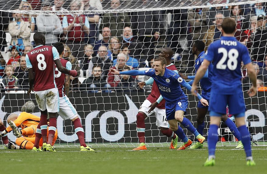Leicester's Jamie Vardy, center, celebrates after scoring during the English Premier League soccer match between West Ham and Leicester City at London Stadium in London, Saturday, March 18, 2017. (AP Photo/Frank Augstein)