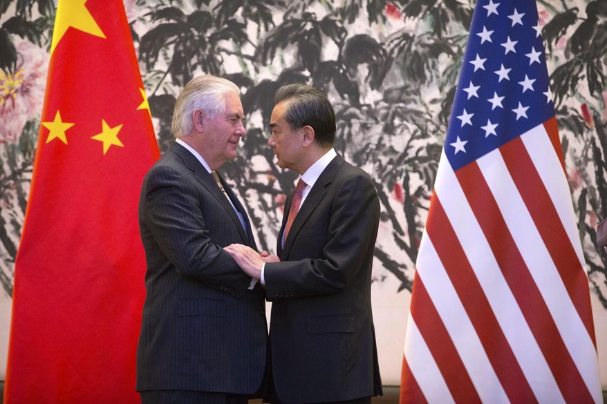 U.S. Secretary of State Rex Tillerson, left, and Chinese Foreign Minister Wang Yi stare each other as they shake hands at the end of a joint press conference following their meeting at the Diaoyutai State Guesthouse in Beijing, China, Saturday, March 18, 2017. Tillerson arrived in Beijing on Saturday for his first face-to-face talks with Chinese leaders expected to focus on North Korea&#39;s nuclear program, trade and South China Sea territorial disputes. (AP Photo/Mark Schiefelbein, Pool)