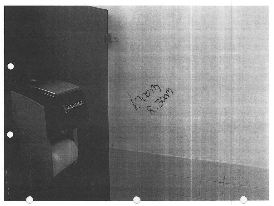 This image provided by the Lacey Police Department shows a June 13, 2007, photo with the words “boom 8:30am” scrawled across a boy’s bathroom at Timberline High School in Lacey, Wash. In 2007, a teenager who was sending bomb threats to his high school in Washington state was finally caught by an FBI agent posing as a journalist. The apparent bomb threat, a picture of which was taken by Lacey police officer Ed McClanahan, was one of several to disrupt life at Timberline between June 3 and 13. The AP obtained a copy of the picture via a public records request. (Lacey Police Department via AP)
