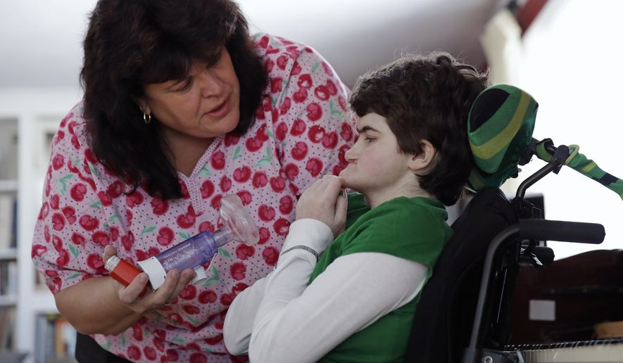 In-home nurse Jane Kern, left, chats with her patient Lexi Gerkin while administering medication at the Gerkin family home in Brentwood, N.H., Friday, March 17, 2017. Pressed by parents of severely sick children, New Hampshire increased Medicaid reimbursement rates for skilled in-home nurses a year ago. But while some families report improvements, the number of shifts being filled has barely budged. (AP Photo/Charles Krupa)